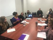 Team Members discussing agenda items at our weekly all-team meeting.