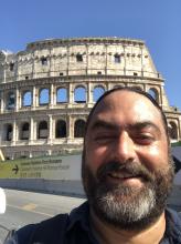 Stephen Tripodi in front of the Colosseum in Rome, Italy.