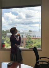 Stephanie Kennedy pondering over ideas written on the conference room windows.