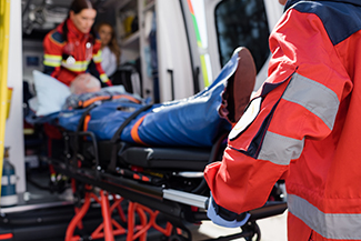 "First responders putting a person into an ambulance."